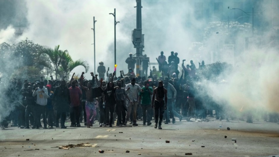 Demonstrators confront Kenyan security forces amid clouds of tear gas during a nationwide strike to protest against tax hikes and the Finance Bill 2024 in downtown Nairobi