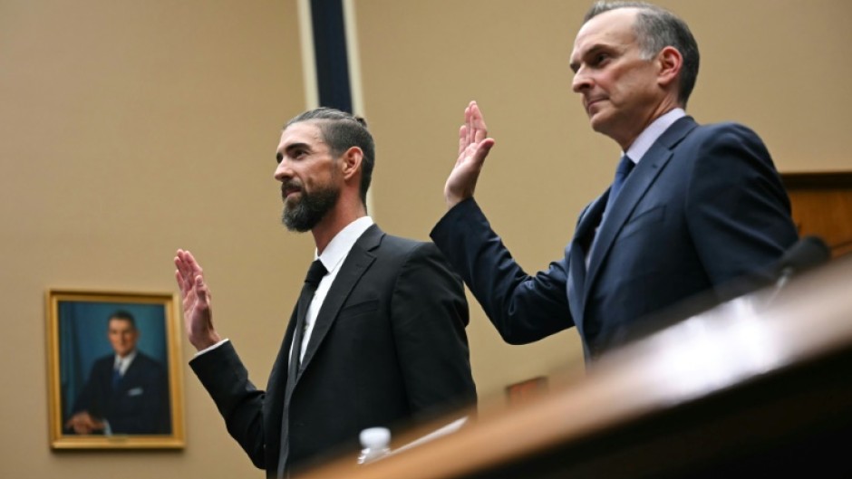 US Olympic swimming legend Michael Phelps (L) and US Anti-Doping Agency chief executive Travis Tygart are sworn in before testimony before a US congressional committee