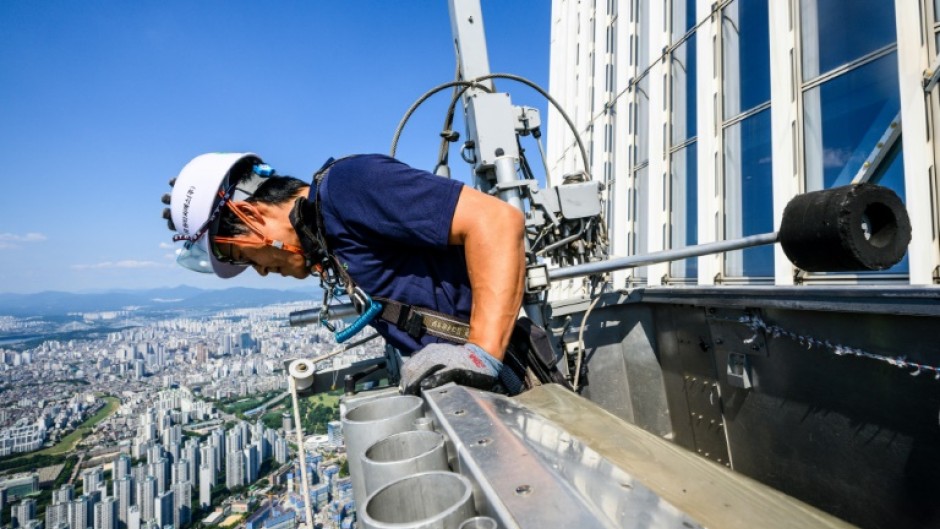 Seo Seung-ho looks down from a special gondola at the Lotte World Tower