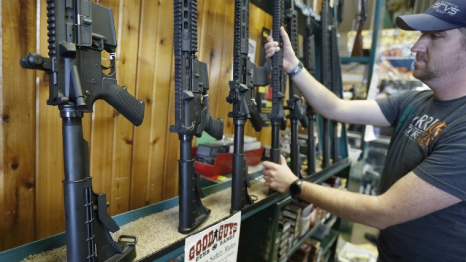 Dordon Brack pulls a semi-automatic AR-15 off the rack at Good Guys Guns & Range on February 15, 2018 in Orem, Utah