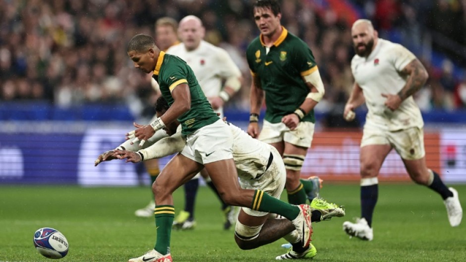 Manie Libbok (L) seeks possession for South Africa in a 2023 Rugby World Cup semi-final victory over England in Paris