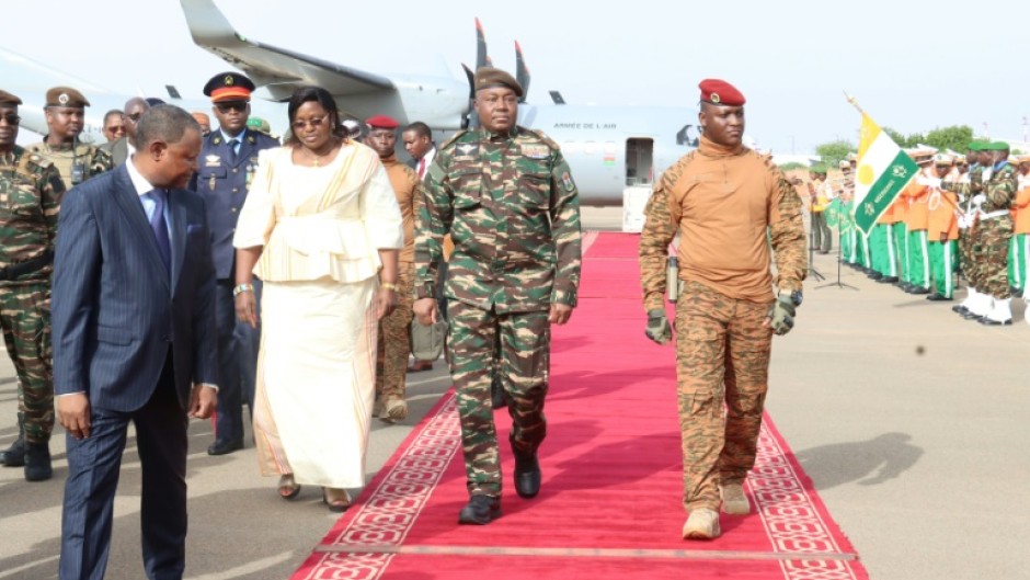 Niger's General Abdourahamane Tiani (C), pictured with his Burkinabe counterpart Captain Ibrahim Traore (R), is calling for the establishment of a 'community far removed from the stranglehold of foreign powers'