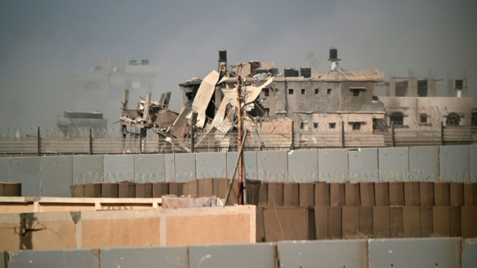 A damaged building in southern Gaza is seen from the Egyptian side of the border