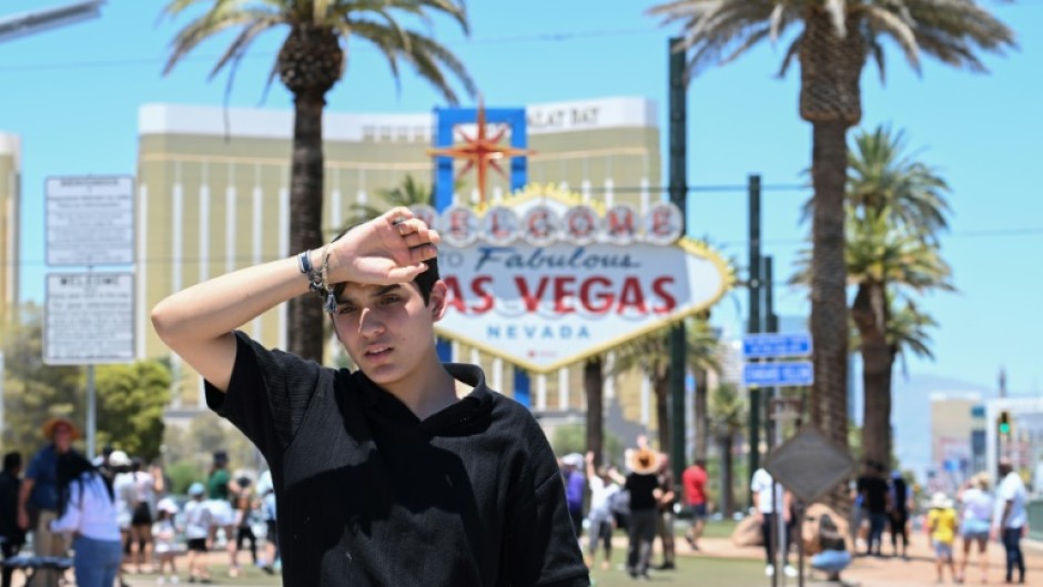 A man walks near the Las Vegas strip during a heatwave in Las Vegas, Nevada, on July 7, 2024