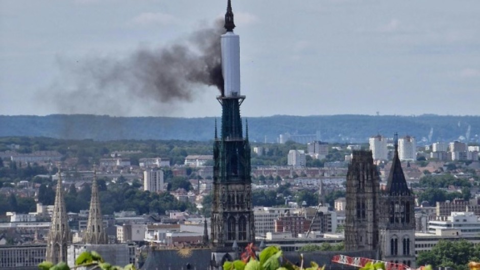 Smoke billows from the spire of Rouen Cathedral in Rouen, northern France on July 11, 2024