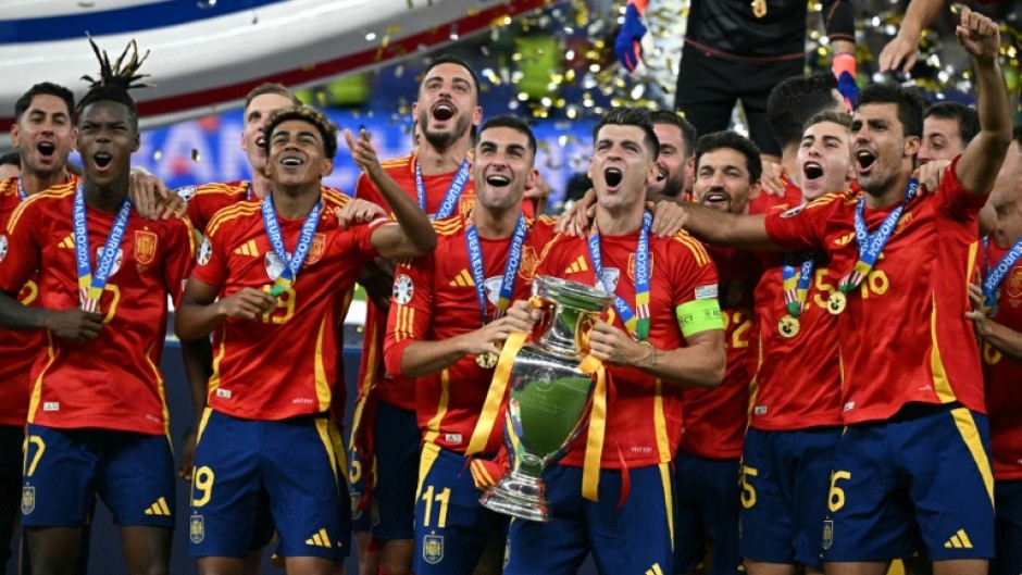 Spain's players celebrate with the Euro 2024 trophy