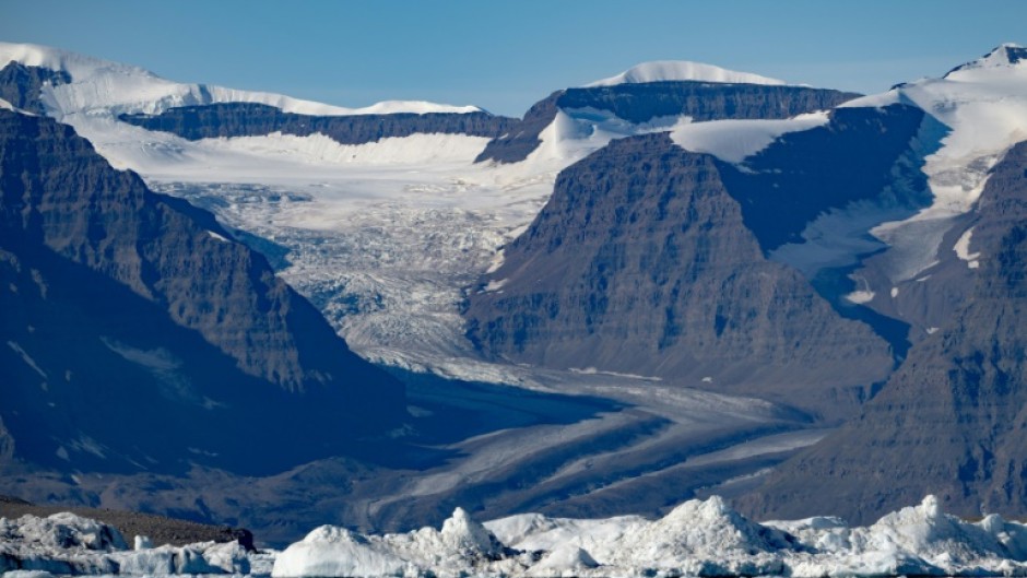 A photograph taken in Scoresby Fjord, Estarn Greenland shows a partly melted glacier