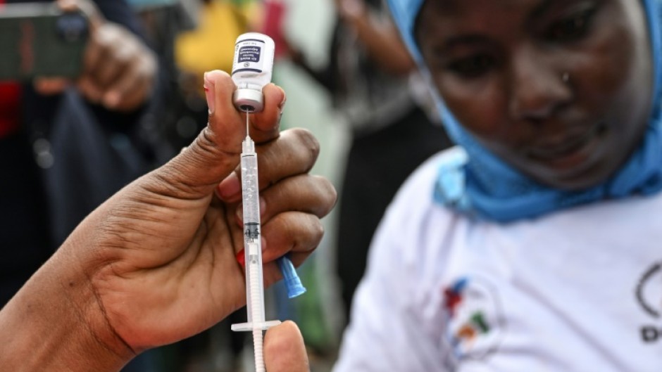 A nurse prepares a dose of a vaccine against malaria on the first day of a vaccination drive in Ivory Coast