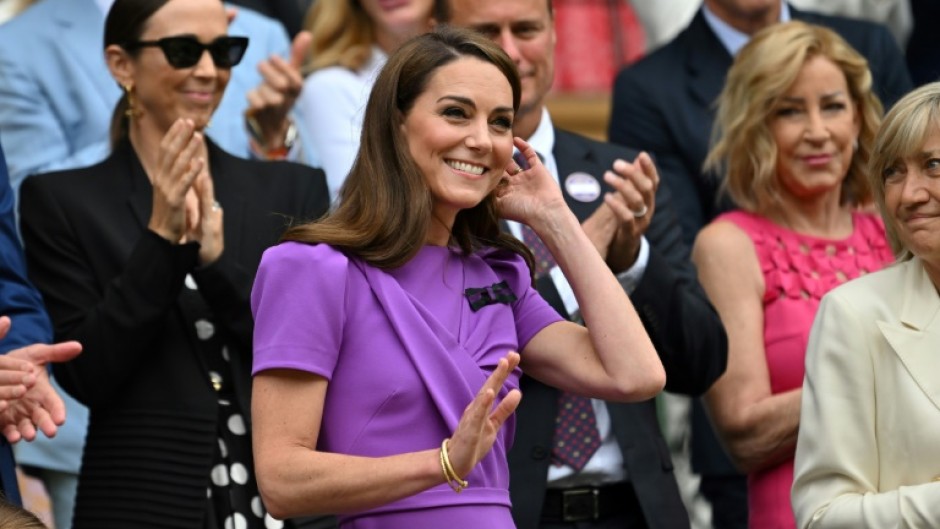 Catherine, Princess of Wales, waves as she takes her seat on Wimbledon's Centre Court 