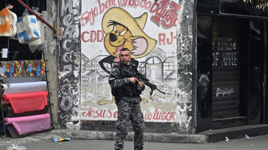 A Military Police officer patrols a street in the Cidade de Deus (City of God) favela inRio de Janeiro