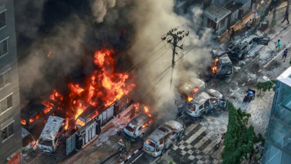 Smoke rises from burning vehicles near Bangladesh's disaster management agency on Thursday