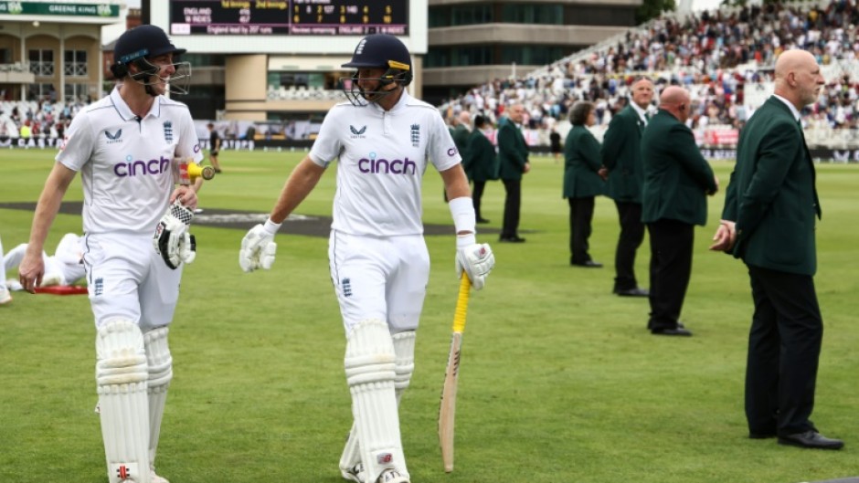 Undefeated: England's Harry Brook (L) and Joe Root return to the pavilion after an unbroken century stand in the second Test against the West Indies at Trent Bridge  