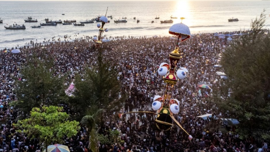 Thousands flock to the coast of western Indonesia to watch two mythical effegies cast into the sea as part of a centuries-old ritual