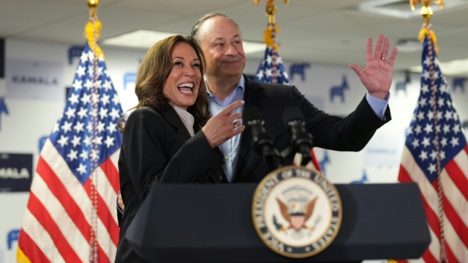 US Vice President Kamala Harris and Second Gentleman Doug Emhoff acknowledge the crowd before Harris spoke at her campaign headquarters in Wilmington, Delaware on July 22, 2024