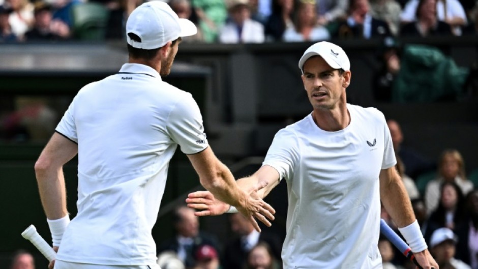 End of the road: Britain's Andy Murray (R) with brother Jamie Murray in action at Wimbledon this year