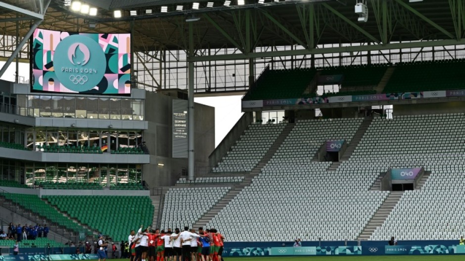 Empty feeling: Morocco's players and staff celebrate at the end of the match with Argentina