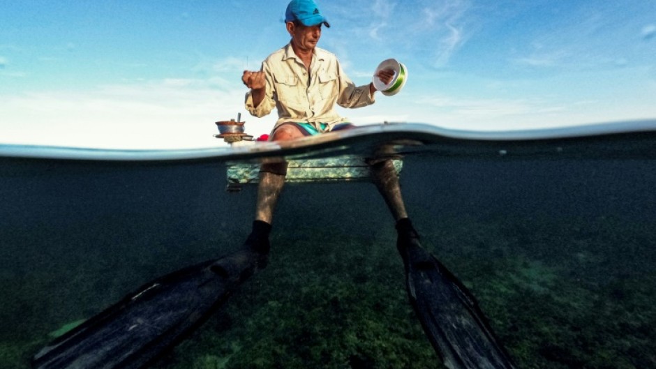 A Cuban fisherman prepares to fish from a makeshift raft in Havana Bay on July 16, 2024