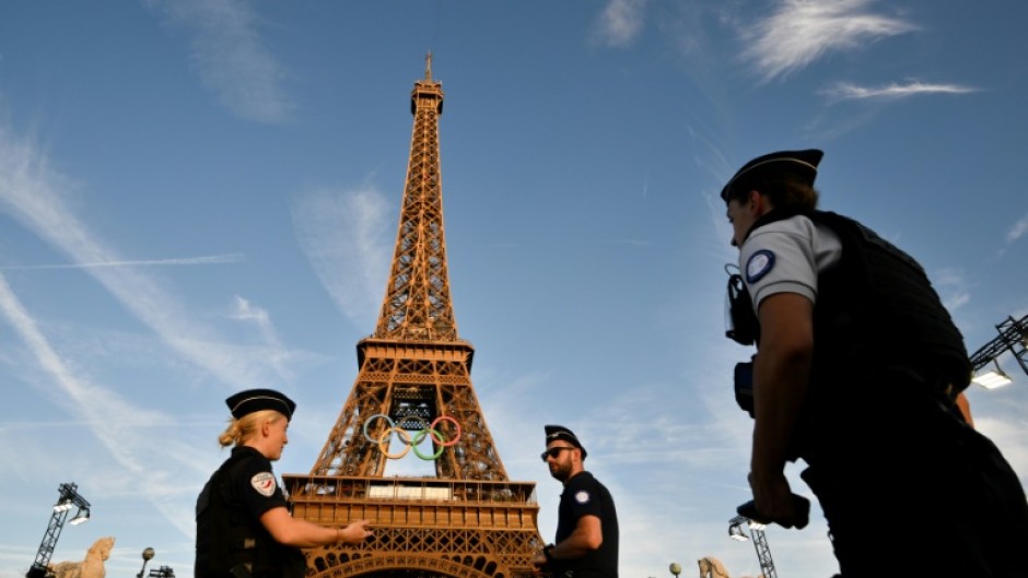 French police officers stand guard in front of the Eiffel Tower 