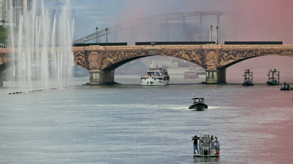 The delegation from Greece sails under Pont d'Austerlitz as the first of the teams to go down the River Seine in the Olympics opening ceremony