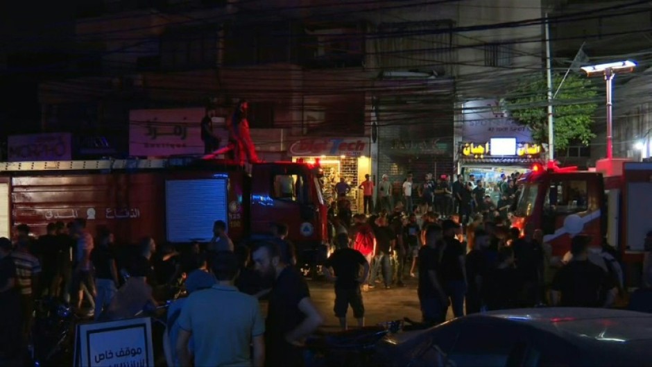 Ambulances crowded around the building targeted in the Israeli strike on Tuesday night