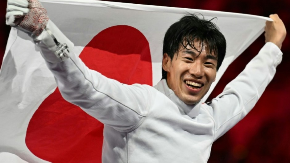 Japan's Koki Kano celebrates winning gold in the men's individual epee