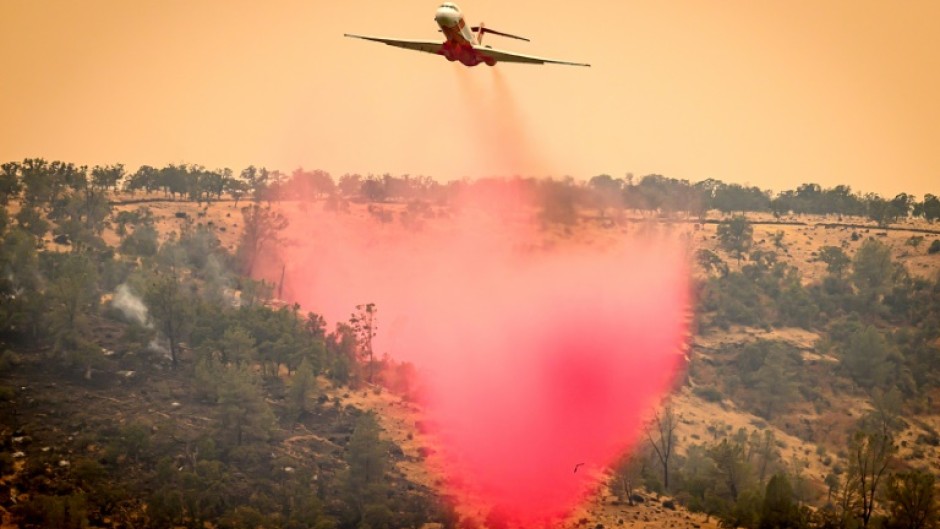 An air tanker drops fire retardant on a ridge as California's Park fire burns on July 27, 2024