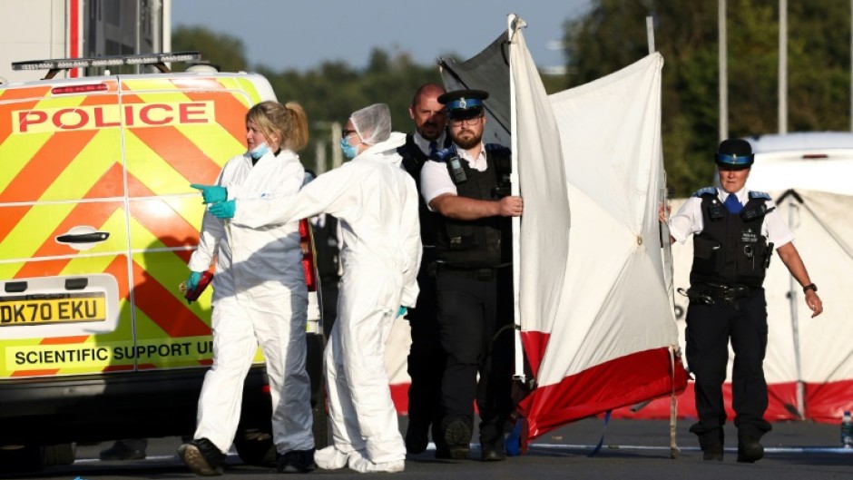 Police officers and forensic personnel put up a fence on Hart Street in Southport, northwest England, on July 29, 2024, following a knife attack