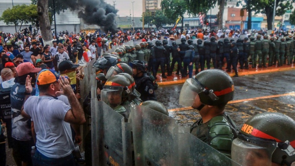 Demonstrators confront riot police during a protest against Venezuelan President Nicolas Maduro's government in Puerto La Cruz on July 29, 2024