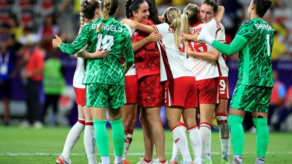 Canada's players celebrate after beating Colombia to qualify for the quarter-finals at the Olympics