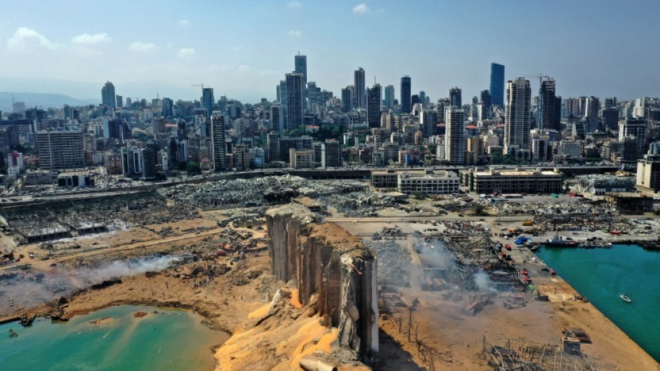 An aerial view on August 5, 2020 of the massive damage to Beirut port's grain silos (C) and surrounding area after a blast tore through the harbour in the heart of the Lebanese capital