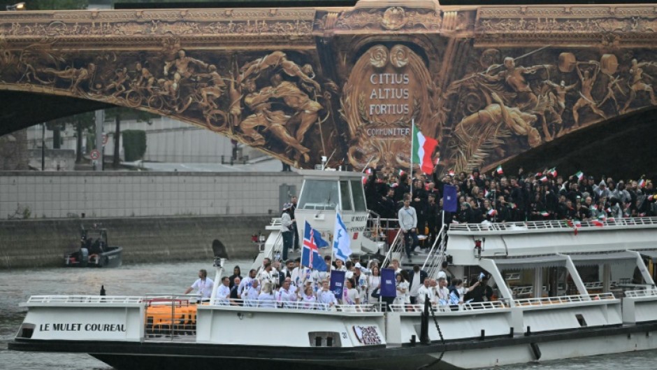 Chad's flag bearer Madaye Israel waves his country's flag (top right)at the Olympics opening ceremony in Paris