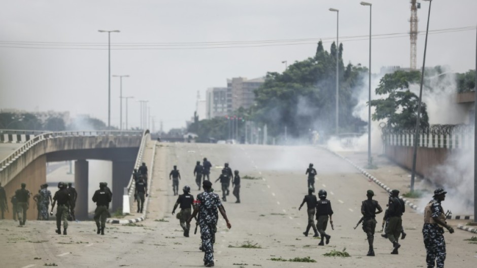 Nigerian security forces fire tear gas during the protests in Abuja