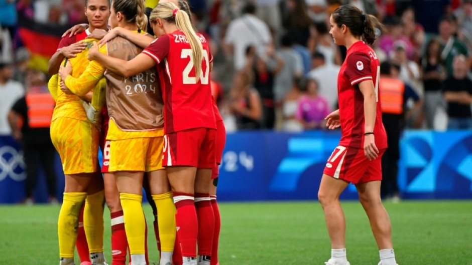 Canada players react after their penalty shoot-out defeat at the hands of Germany in Marseille