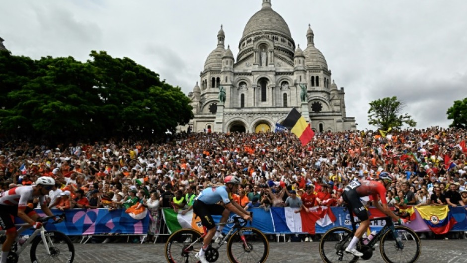 Gold medallist Remco Evenepoel racing past the Sacre Coeur cathedral during the men's cycling road race 
