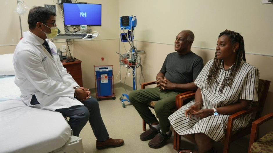 Doctor Satish Nadig (L), professor of surgery at the Northwestern University-Feinberg School of Medicine, speaks with patient, Harry Stackhouse (C), 74, and his daughter Trewaunda Stackhouse, 45, in a clinic post-transplant room at Northwestern Medicine 