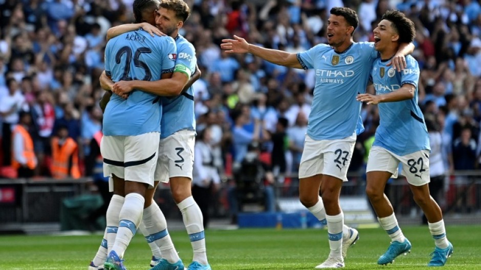 Manuel Akanji (left) scored the winning penalty as Manchester City beat Manchester United in the Community Shield