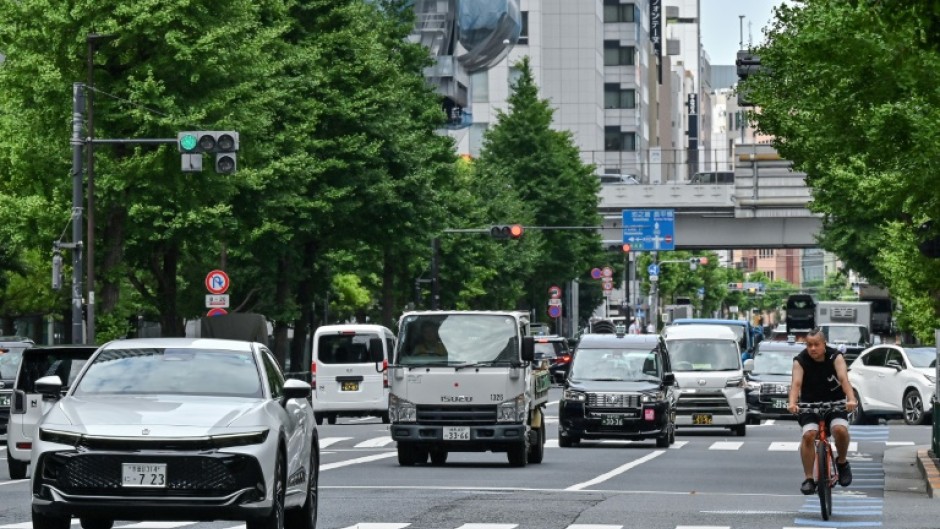 A cyclist navigates through traffic in the business district of Otemachi in central Tokyo. Japanese earthquake scientists have warned of the possibility of a "megaquake" in the future, although the risk is low