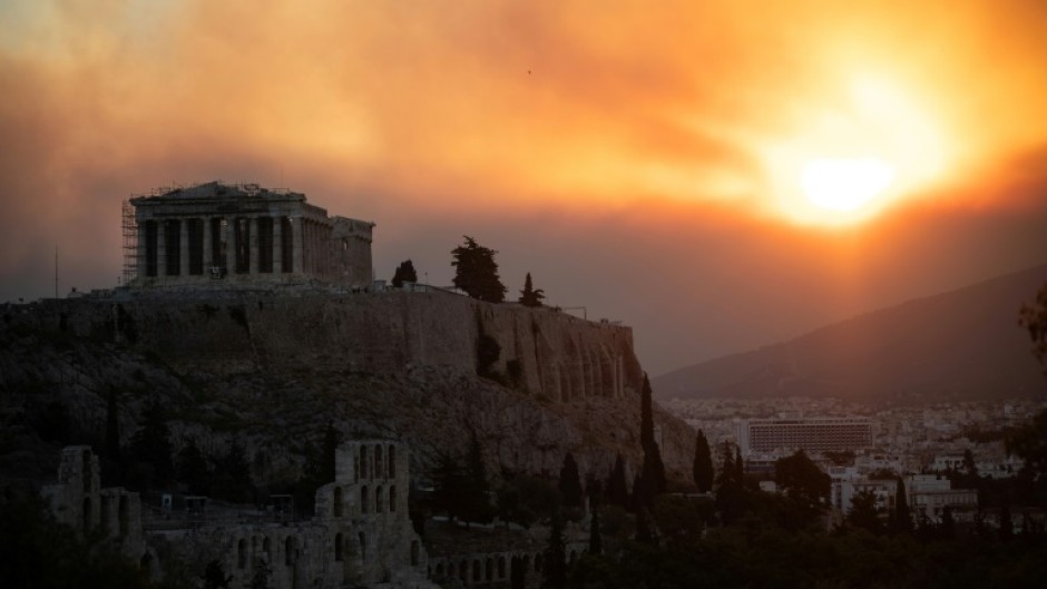 The Parthenon temple in Athens with a smoke cloud from a wildfire in the background. Thousands of people have been ordered evacuated from towns and villages near the capital