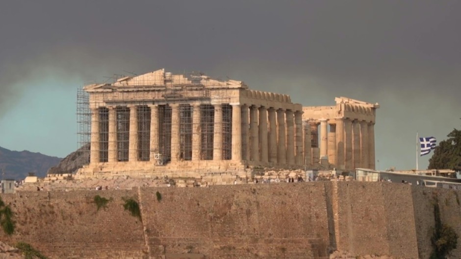 The Parthenon temple atop the Acropolis hill in a cloud of smoke from a wildfire threatening the Athens suburbs