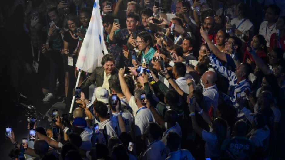 Hollywood star Tom Cruise abseiled into the stadium and made off with the Olympics flag on a motorbike 