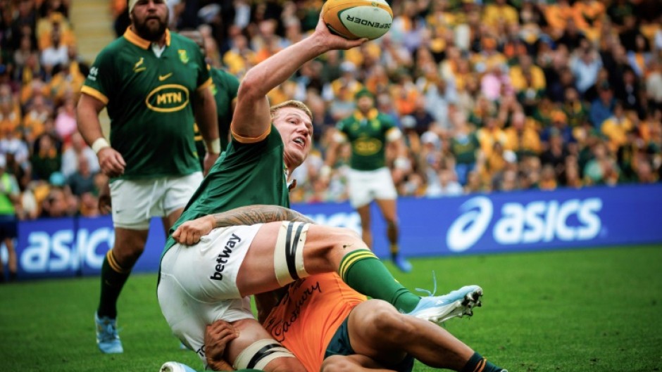 South Africa's Pieter-Steph du Toit (left) looks to offload as he is tackled by Australia's Len Ikitau 