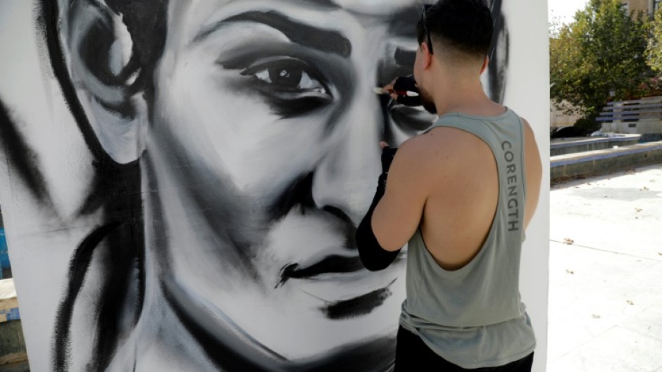 An artist paints a large portrait of Algerian Olympic boxing champion Imane Khelif in her hometown Tiaret