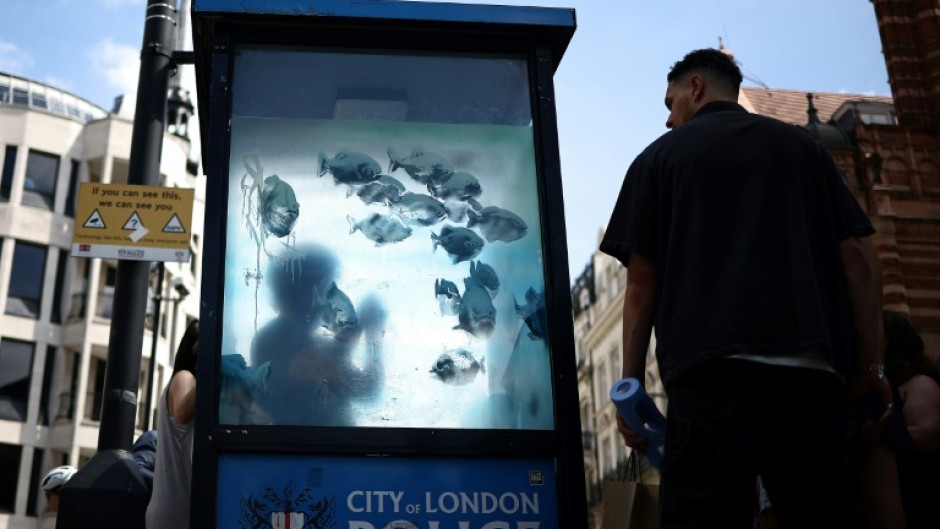 Two police officers could be seen examining the design and taking pictures of it on Sunday