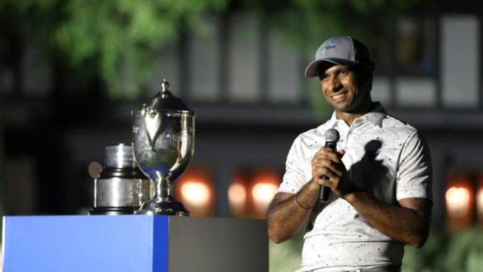 Aaron Rai of England accepts the trophy after winning his first PGA Tour title at the Wyndham Championship