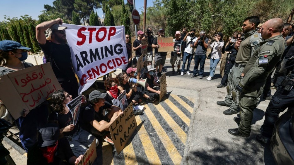 Israeli security force members stand guard during an anti-war sit-in by Israeli left-wing activists, outside the British Consulate General in Jerusalem, with Britain's Foreign Secretary David Lammy expected to arrive for talks