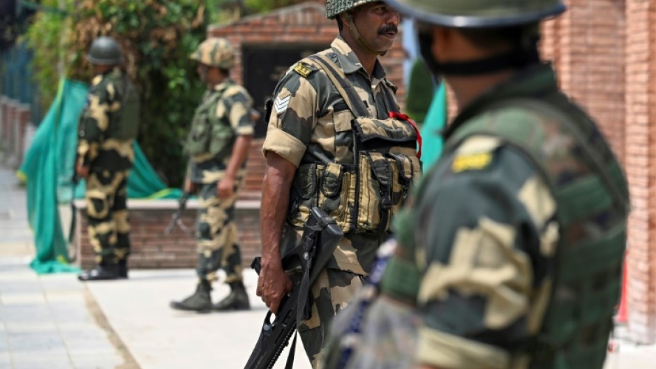 Indian forces stand guard on a street in Srinagar on Friday. Indian-administered Jammu and Kashmir will hold elections for the assembly of the disputed region for the first time in a decade, starting in September