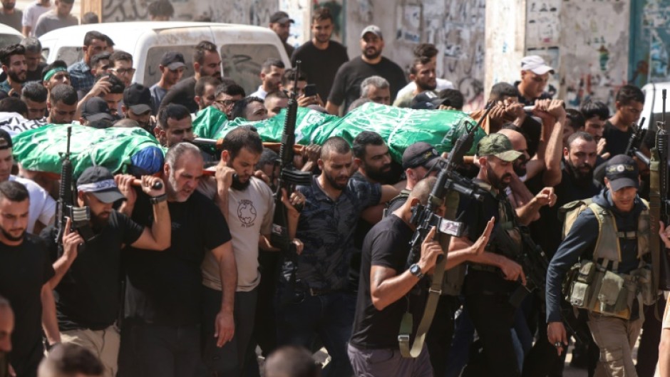 Mourners carry the bodies of two Palestinian Hamas militants killed in an Israeli air strike on Jenin in the occupied West Bank