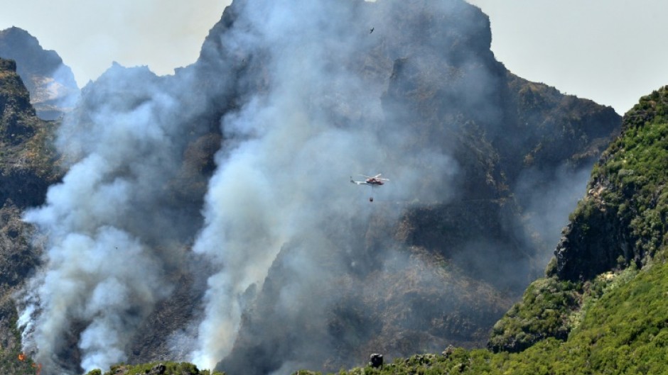 More than 100 firefighters are battling the blaze on two main fronts on the island