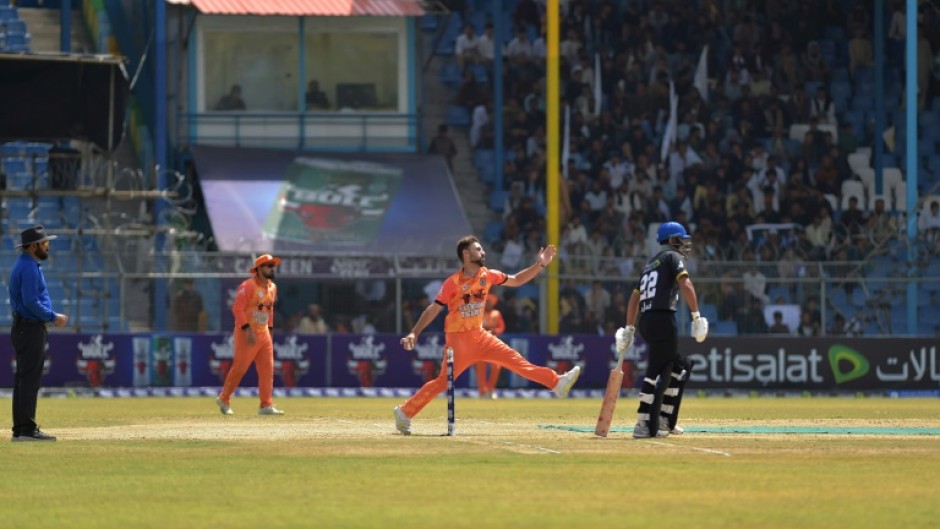 Afghan Cricket players from the Speen Ghar Tigers team (Orange) play against the Mis-e-Ainak Knights (Black) during Afghanistan's leading T20 cricket league 'Shpageeza' at the Kabul Cricket Stadium on August 22, 2024