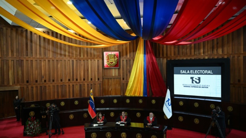 The presiding judge of Venezuela's Supreme Court, Caryslia Rodriguez (C), reads the court's ruling certifying President Nicolas Maduro's reelection